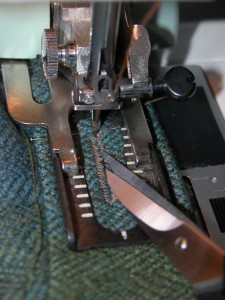 After the buttonhole is stitched, before removing the fabric from the machine, use a very sharp pair of little scissors and cut the buttonhole apart.