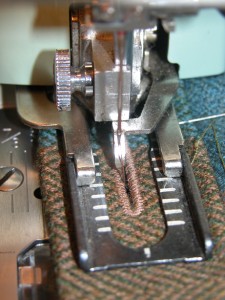 Go around a second time with the slightly wider buttonhole, and it will cover the cut edge of the buttonhole.